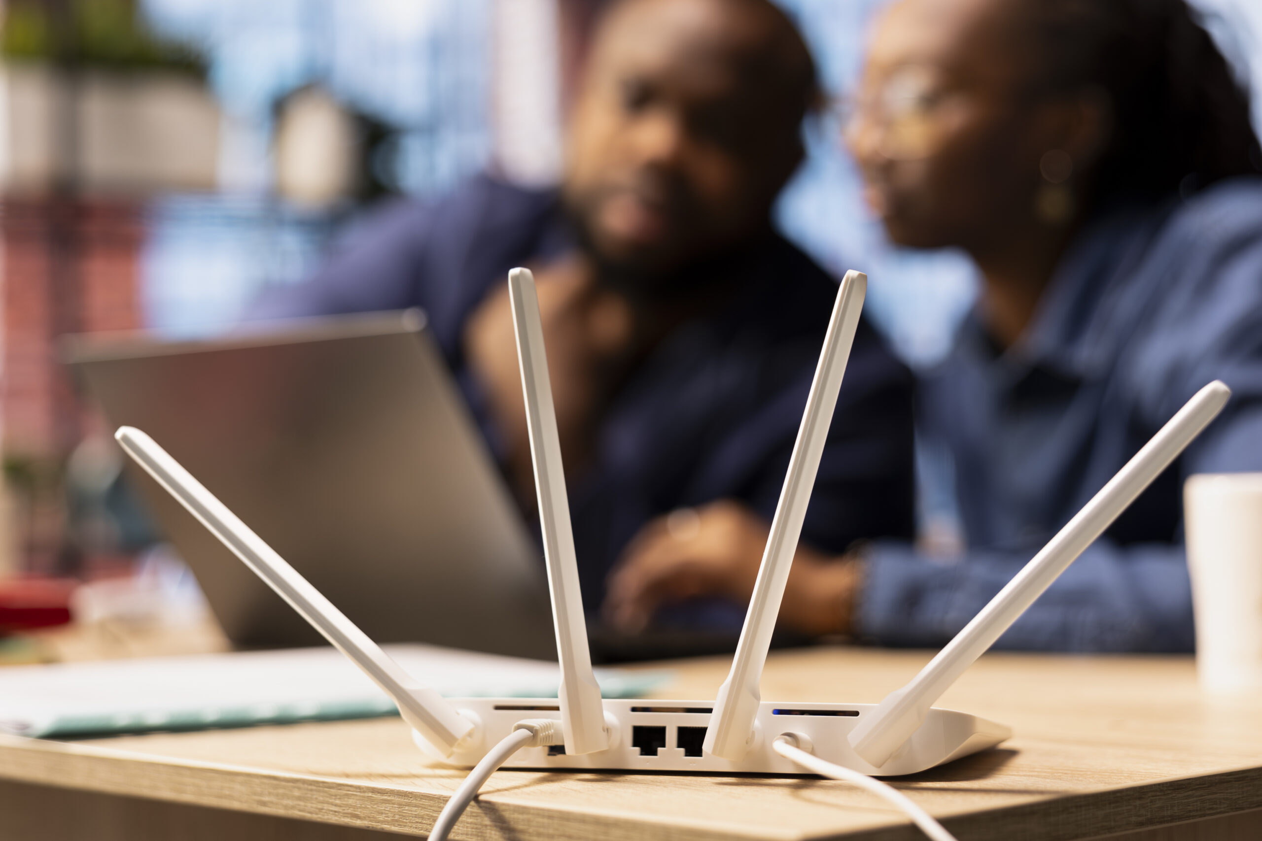 Black couple at home examine the modem setup and troubleshooting online guides, working together to fix Wi Fi router and restore their internet connection for remote freelance tasks.